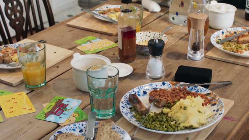 TV on, meals at the dining table half eaten