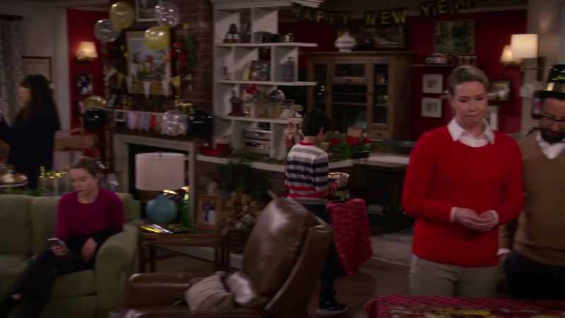 [TV playing indistinctly]