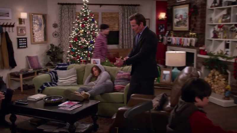 [TV playing indistinctly]