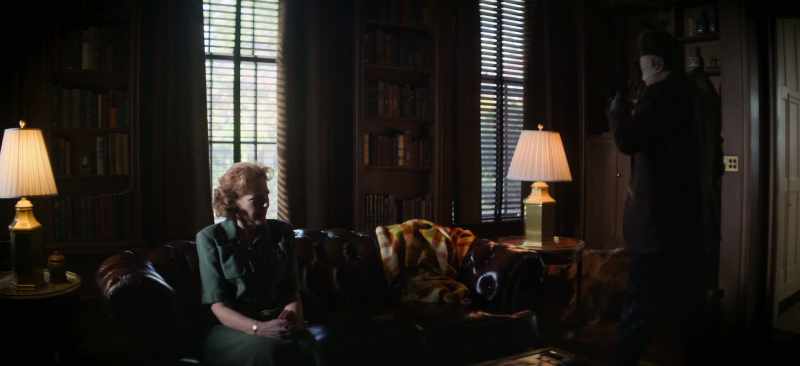 [TV playing indistinctly]