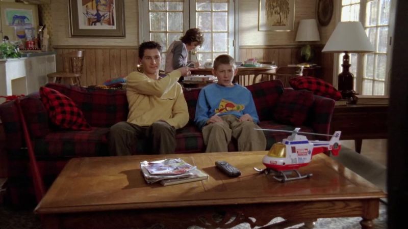 [TV playing]