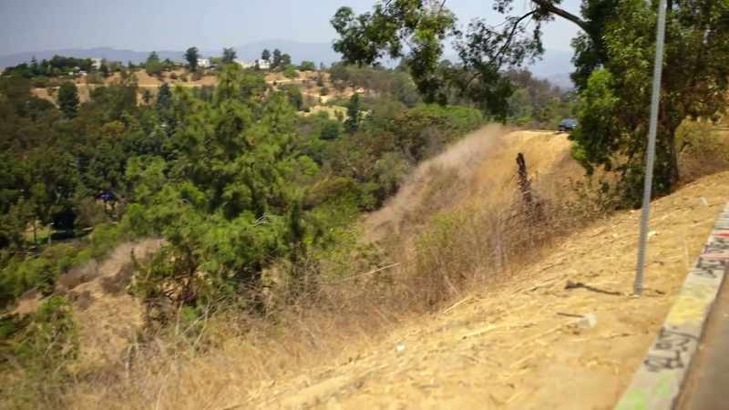Two little boys riding their bikes started looking down the hillside