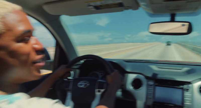 (UPBEAT MUSIC PLAYING ON CAR STEREO)