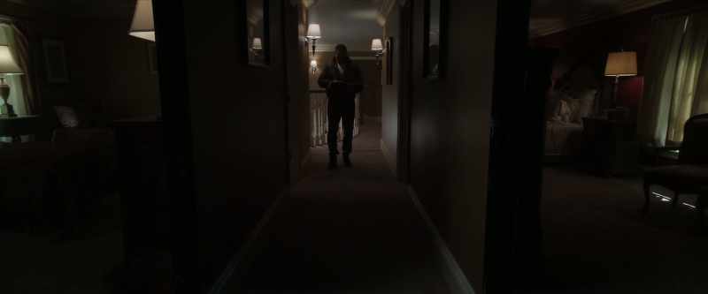 Walks down hallway to