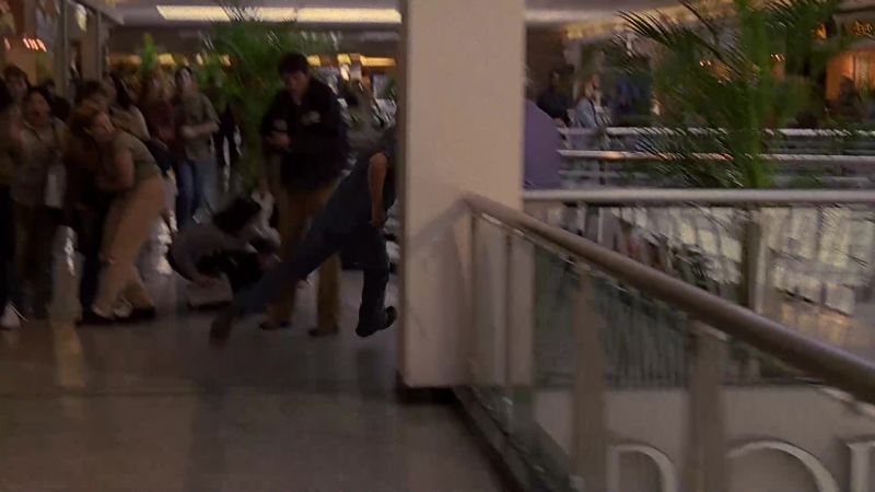 We have an officer down. Kyle Singer is not in custody