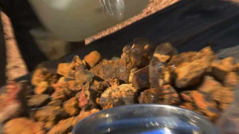 Wetting the rocks allows the opal to shine through