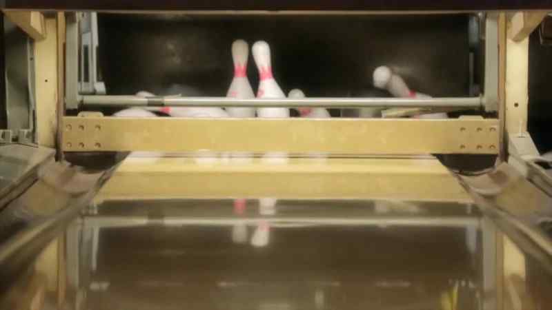 When the bowling ball smashes into the pins