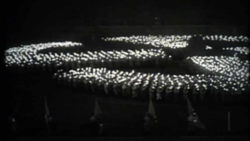 With swastikas, marching people in uniforms