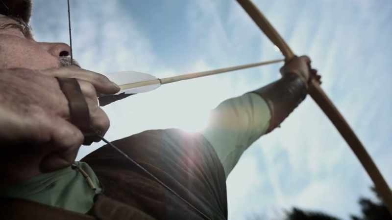 With the bow and arrow
