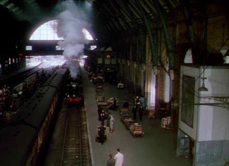 [Woman on p.a.] train now arriving at platform one