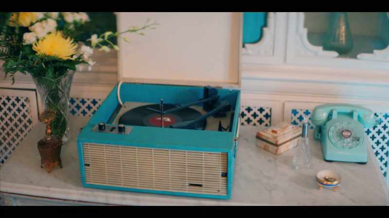 WOMAN ON RECORD PLAYER: Prim and proper