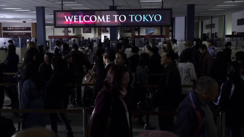 (woman speaks Japanese over P.A.)