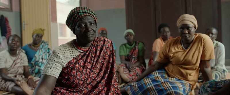 [woman starts singing in Dinka]