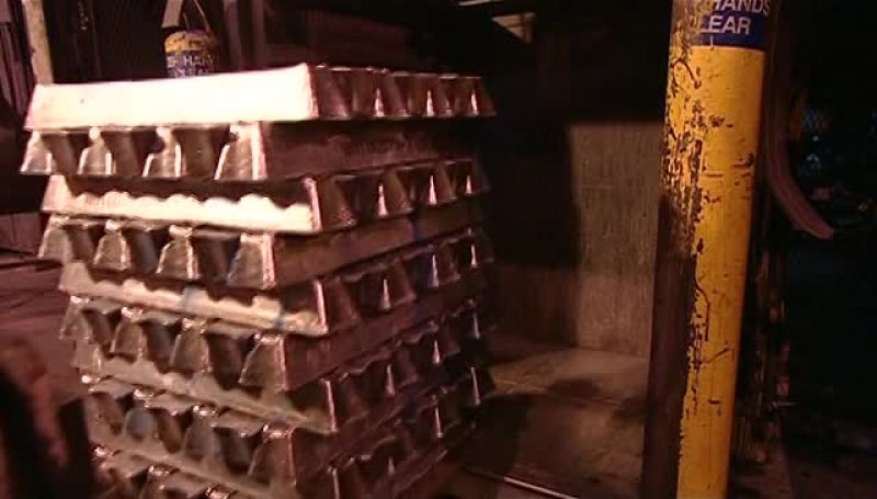 WORKERS LOAD ALUMINUM INGOTS