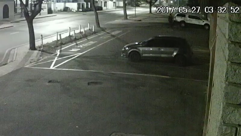 You can see the men looking at the car